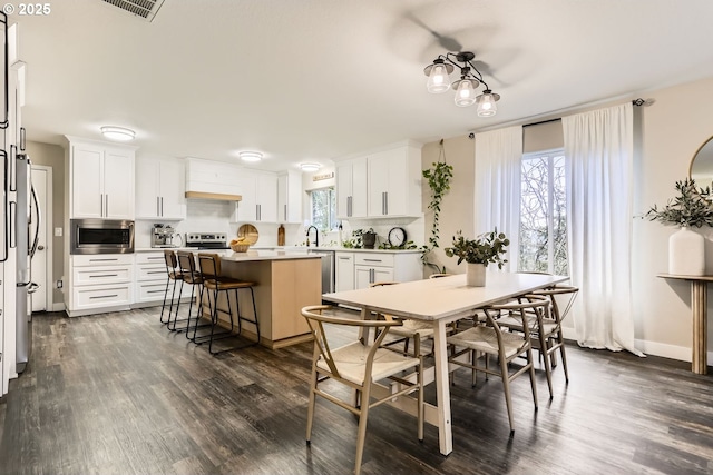 dining room featuring dark hardwood / wood-style floors and sink