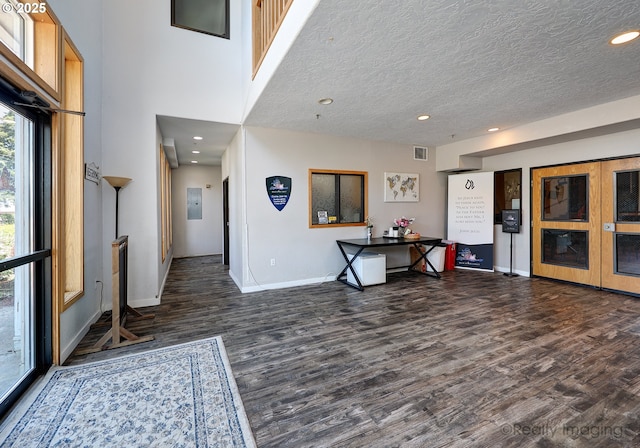 5740 NE Lombard St, Portland, OR 97218 - foyer entrance with dark wood finished floors, baseboards, recessed lighting, and a textured ceiling