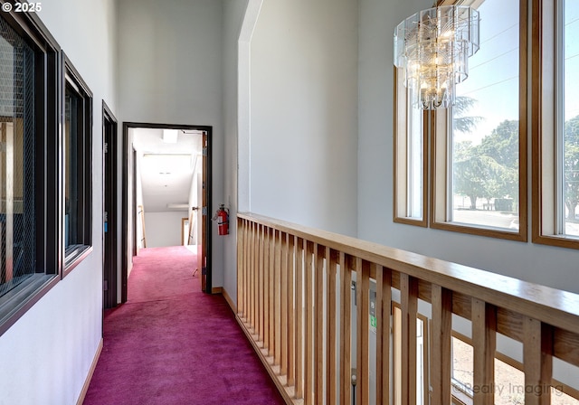 5740 NE Lombard St, Portland, OR 97218 - corridor featuring dark carpet and a chandelier