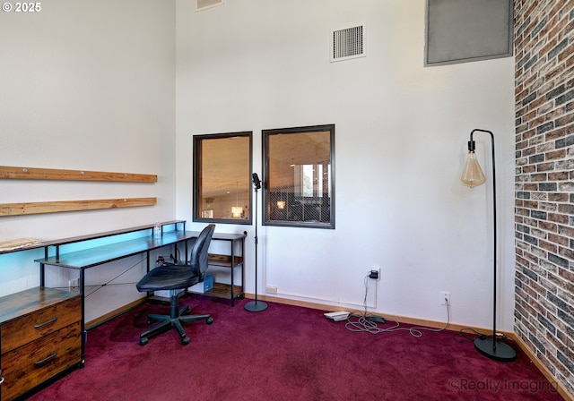 5740 NE Lombard St, Portland, OR 97218 - office featuring carpet, baseboards, brick wall, and a towering ceiling