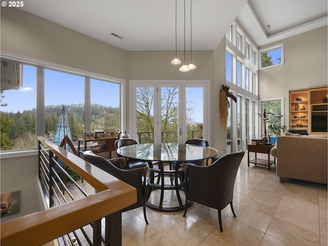 tiled dining room featuring a chandelier and plenty of natural light