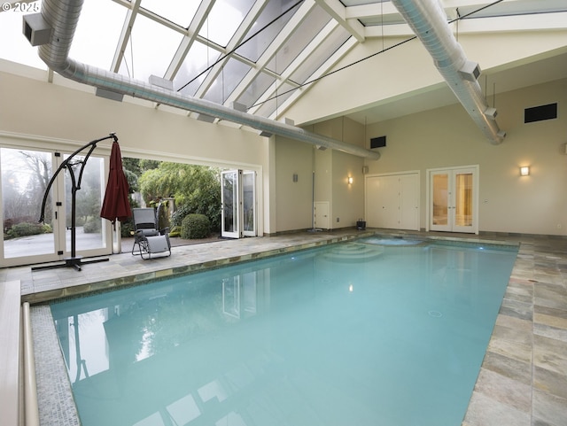 view of pool featuring glass enclosure and a patio area