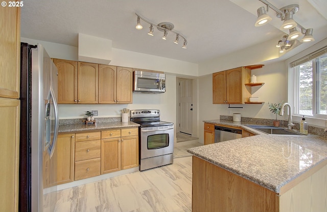 504 NW Fargo St, Camas, WA 98607 - kitchen featuring appliances with stainless steel finishes, a sink, track lighting, a peninsula, and open shelves