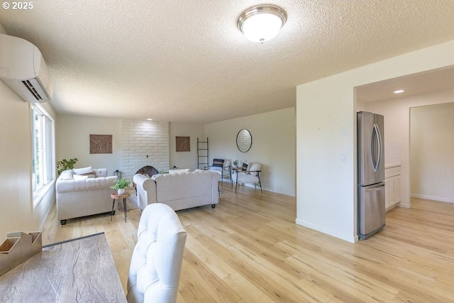 435 E 53rd Ave, Eugene, OR 97405 - living room featuring a wall unit AC, a textured ceiling, light wood-type flooring, and a fireplace