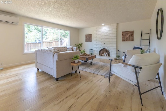 435 E 53rd Ave, Eugene, OR 97405 - living area featuring a textured ceiling, a wall mounted air conditioner, light wood-style floors, and a fireplace