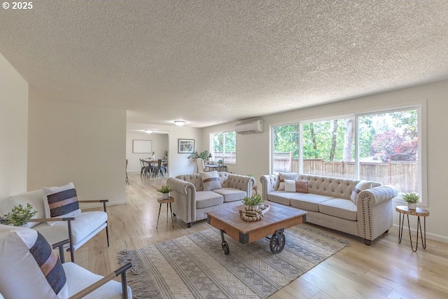 435 E 53rd Ave, Eugene, OR 97405 - living room featuring a wall unit AC, a textured ceiling, and light wood-type flooring