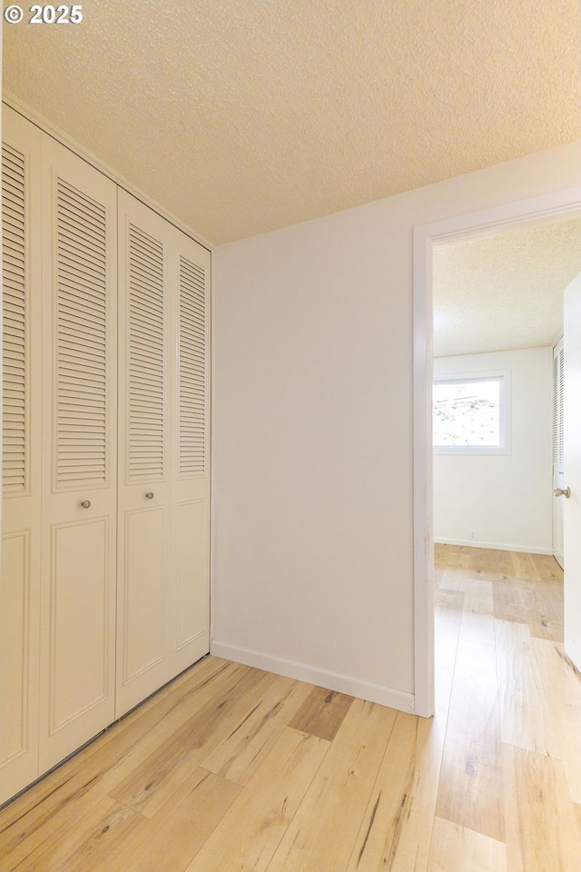 435 E 53rd Ave, Eugene, OR 97405 - unfurnished bedroom with a closet, light wood-style flooring, and a textured ceiling