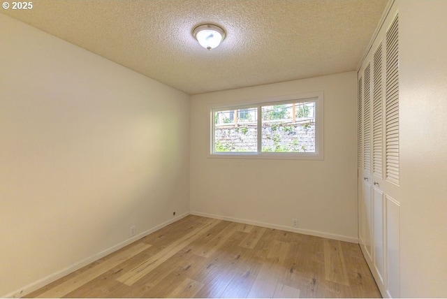 435 E 53rd Ave, Eugene, OR 97405 - unfurnished bedroom featuring a closet, light wood finished floors, and a textured ceiling