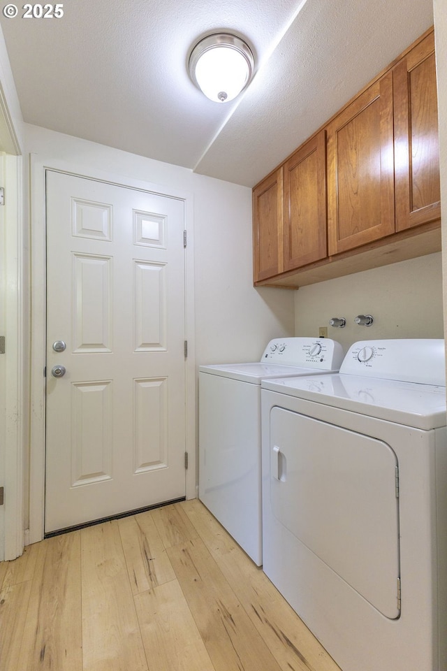 435 E 53rd Ave, Eugene, OR 97405 - laundry area with cabinet space, light wood-style flooring, and washer and dryer