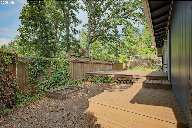 435 E 53rd Ave, Eugene, OR 97405 - wooden terrace featuring a fenced backyard and a vegetable garden