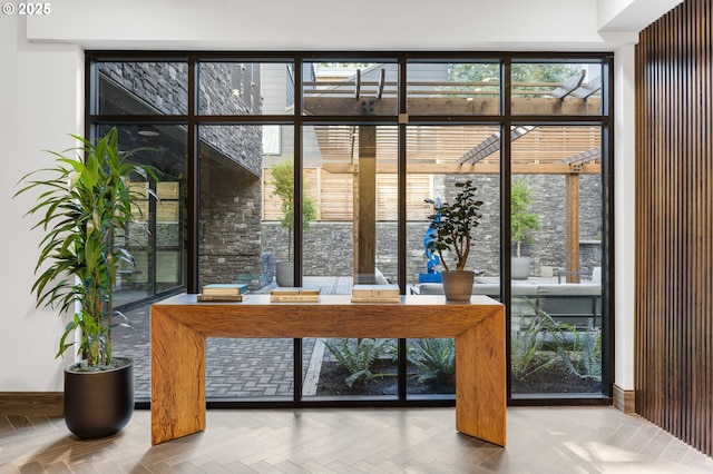 entryway with parquet floors and plenty of natural light