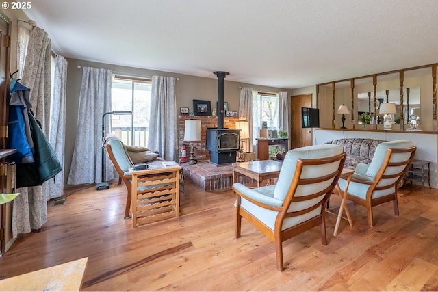 5383 Sunshine Rd, Roseburg, OR 97470 - living room with a wood stove, light wood-type flooring, and plenty of natural light