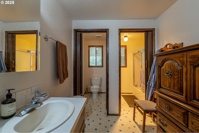 5383 Sunshine Rd, Roseburg, OR 97470 - full bathroom featuring visible vents, toilet, vanity, tile patterned floors, and a shower with shower door