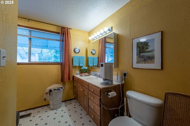 5383 Sunshine Rd, Roseburg, OR 97470 - half bath featuring toilet, a textured wall, a textured ceiling, vanity, and tile patterned floors