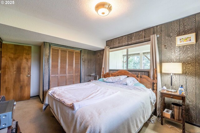 5383 Sunshine Rd, Roseburg, OR 97470 - carpeted bedroom with wood walls, a textured ceiling, and a closet