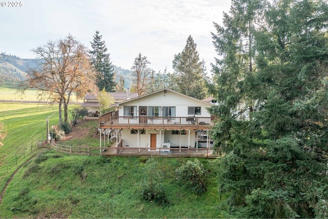 5383 Sunshine Rd, Roseburg, OR 97470 - back of house featuring a rural view, a yard, a deck with mountain view, and fence