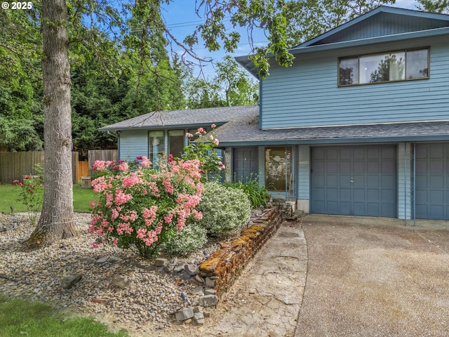 16620 SE Ladd Ct, Milwaukie, OR 97267 - tri-level home with driveway, a garage, and roof with shingles