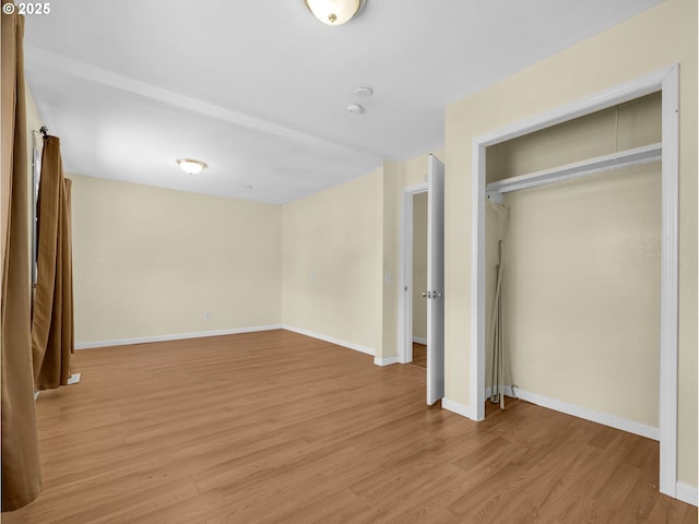 125 SW Cedar Ave, Warrenton, OR 97146 - unfurnished bedroom featuring light wood-style flooring and a closet