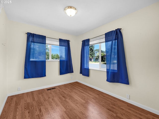 125 SW Cedar Ave, Warrenton, OR 97146 - unfurnished room featuring plenty of natural light and wood finished floors