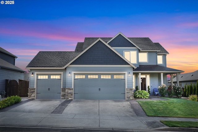 132 N 39th Ct, Ridgefield, WA 98642 - view of front of property featuring an attached garage, driveway, stone siding, and roof with shingles