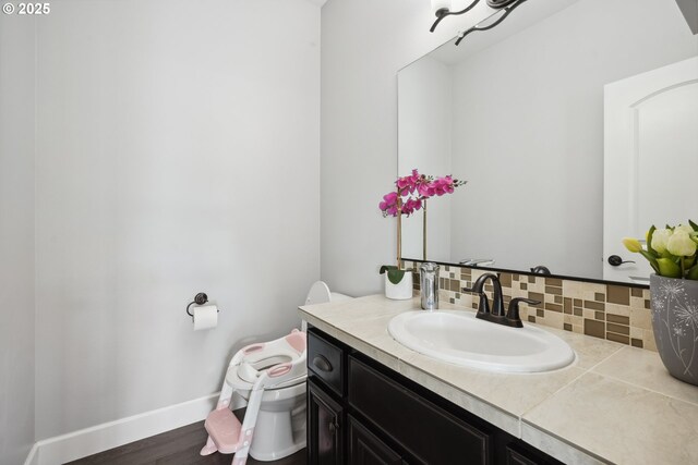 132 N 39th Ct, Ridgefield, WA 98642 - bathroom featuring vanity, tasteful backsplash, and wood finished floors