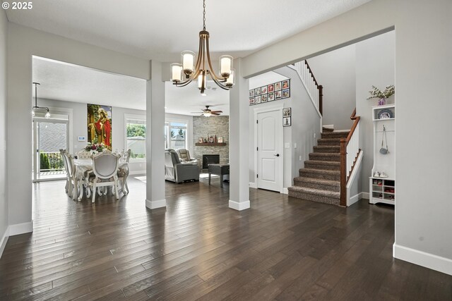 132 N 39th Ct, Ridgefield, WA 98642 - dining room with ceiling fan, stairway, a chandelier, and a fireplace