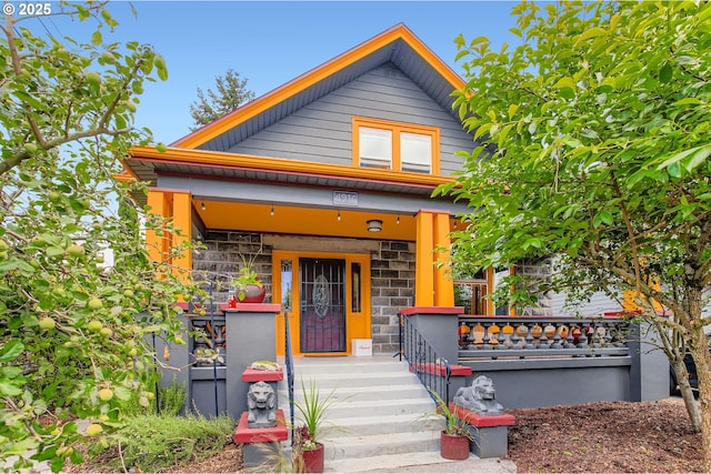 4916 SE 76th Ave, Portland, OR 97206 - shotgun-style home with stone siding and covered porch