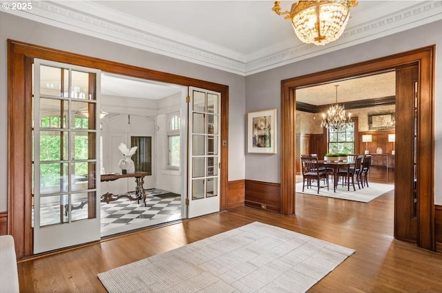 1965 SW Montgomery Pl, Portland, OR 97201 - foyer entrance with a chandelier, wood finished floors, ornamental molding, french doors, and a wainscoted wall