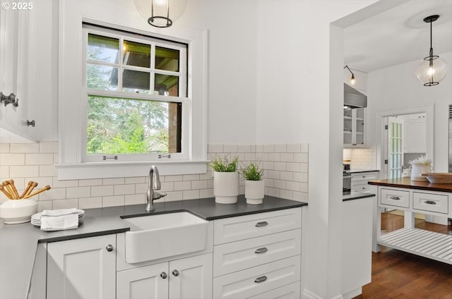 1965 SW Montgomery Pl, Portland, OR 97201 - kitchen with a sink, dark countertops, decorative backsplash, and white cabinets