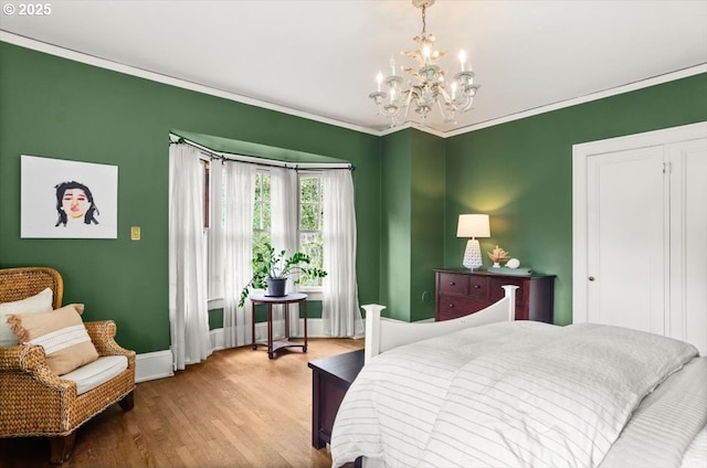 1965 SW Montgomery Pl, Portland, OR 97201 - bedroom featuring a chandelier, wood finished floors, baseboards, and crown molding