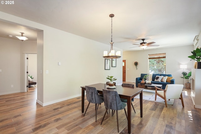 dining room with light wood-style floors, baseboards, and ceiling fan