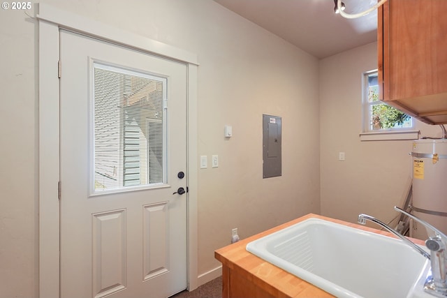 washroom with electric panel, cabinet space, strapped water heater, and baseboards