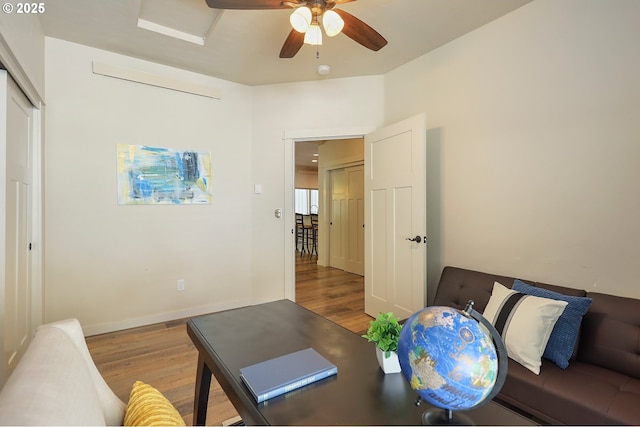 office space with ceiling fan, baseboards, and wood finished floors