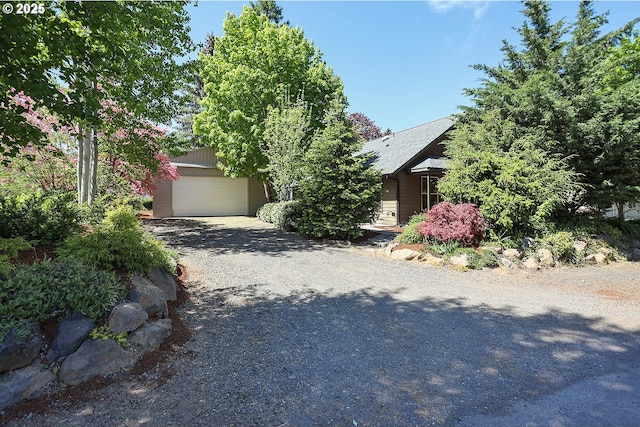 obstructed view of property featuring an attached garage and driveway