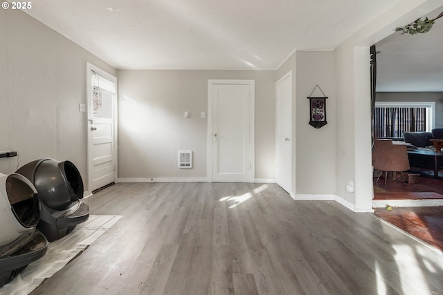 interior space featuring heating unit and light wood-type flooring