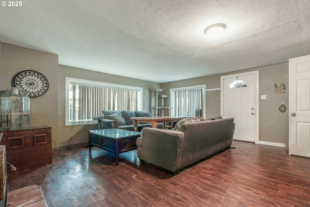 living room featuring dark hardwood / wood-style floors and a textured ceiling