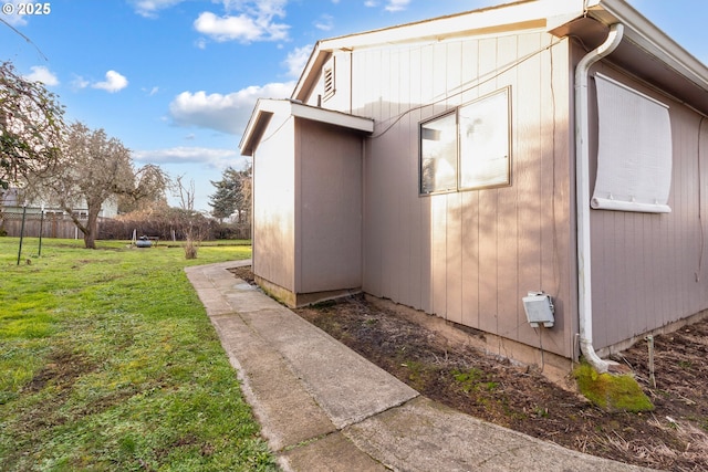 view of side of property with a lawn