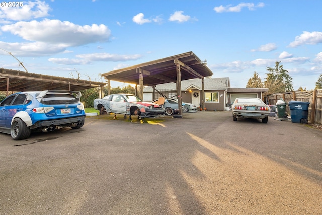 view of parking / parking lot featuring a carport and a garage