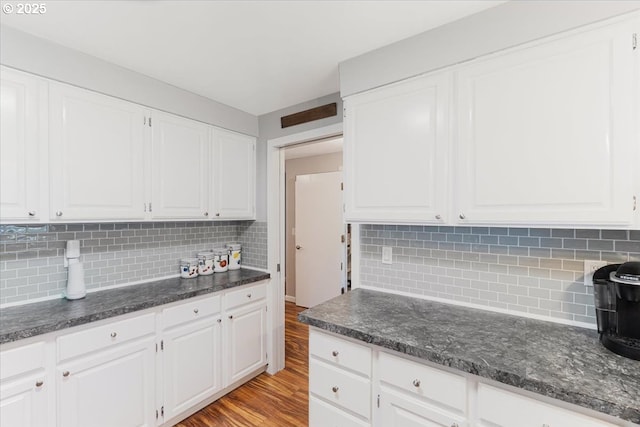 14797 SW Willamette St, Sherwood, OR 97140 - kitchen with white cabinets, light wood-style flooring, and decorative backsplash