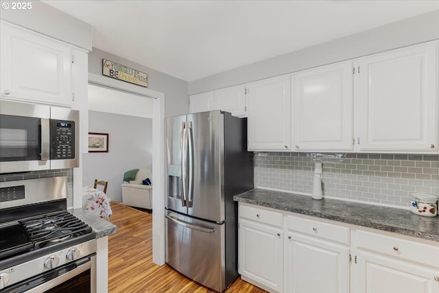 14797 SW Willamette St, Sherwood, OR 97140 - kitchen with appliances with stainless steel finishes, tasteful backsplash, light wood-type flooring, and white cabinets