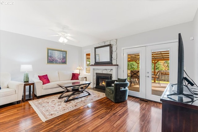 14797 SW Willamette St, Sherwood, OR 97140 - living area with french doors, dark wood-style flooring, a ceiling fan, and a high end fireplace