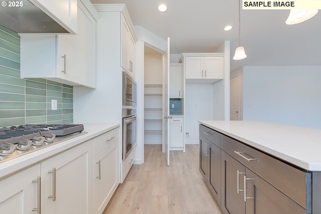 1496 NE Josephine Ct Unit 181, Estacada, OR 97023 - kitchen with stainless steel appliances, tasteful backsplash, white cabinetry, and recessed lighting