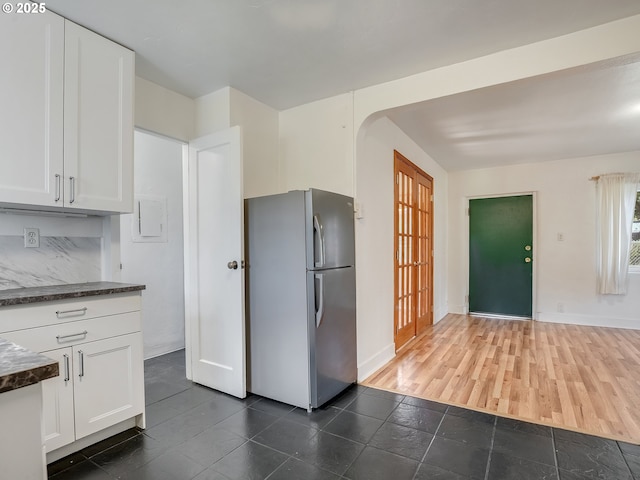 12226 SE Raymond St, Portland, OR 97236 - kitchen featuring freestanding refrigerator, dark countertops, and white cabinetry