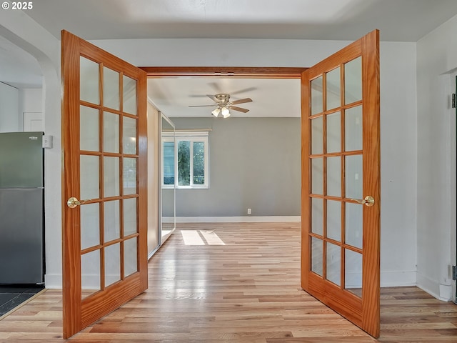 12226 SE Raymond St, Portland, OR 97236 - hall featuring wood finished floors, baseboards, and arched walkways