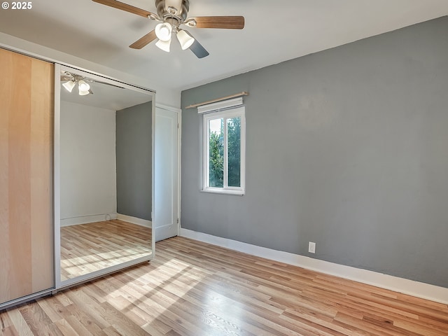12226 SE Raymond St, Portland, OR 97236 - unfurnished bedroom with wood finished floors, a closet, baseboards, and a ceiling fan