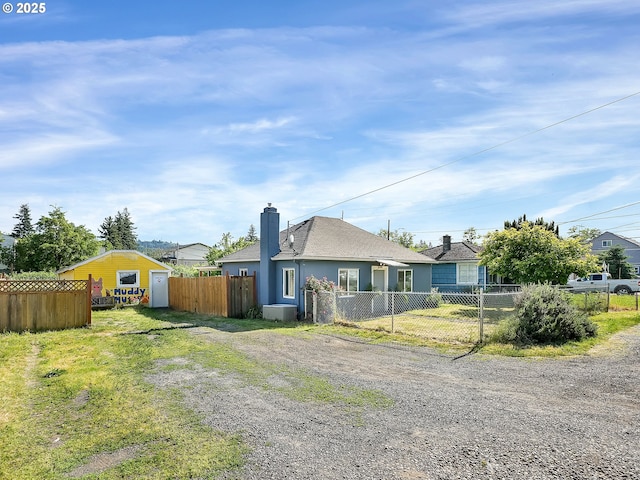 12226 SE Raymond St, Portland, OR 97236 - view of front of home with a chimney, stucco siding, and driveway