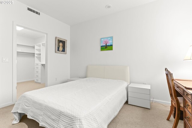 1150 NW Quimby St Unit 442, Portland, OR 97209 - carpeted bedroom with baseboards, a walk in closet, and a closet