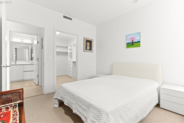 1150 NW Quimby St Unit 442, Portland, OR 97209 - bedroom featuring light colored carpet, a spacious closet, and a closet