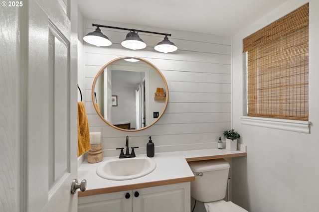 bathroom featuring toilet and vanity
