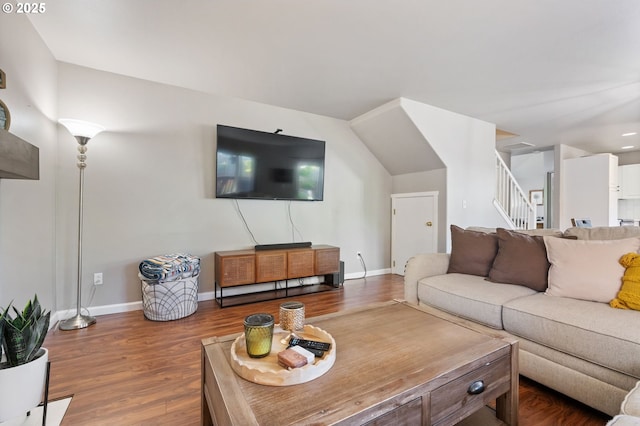 living area featuring stairway, baseboards, and wood finished floors